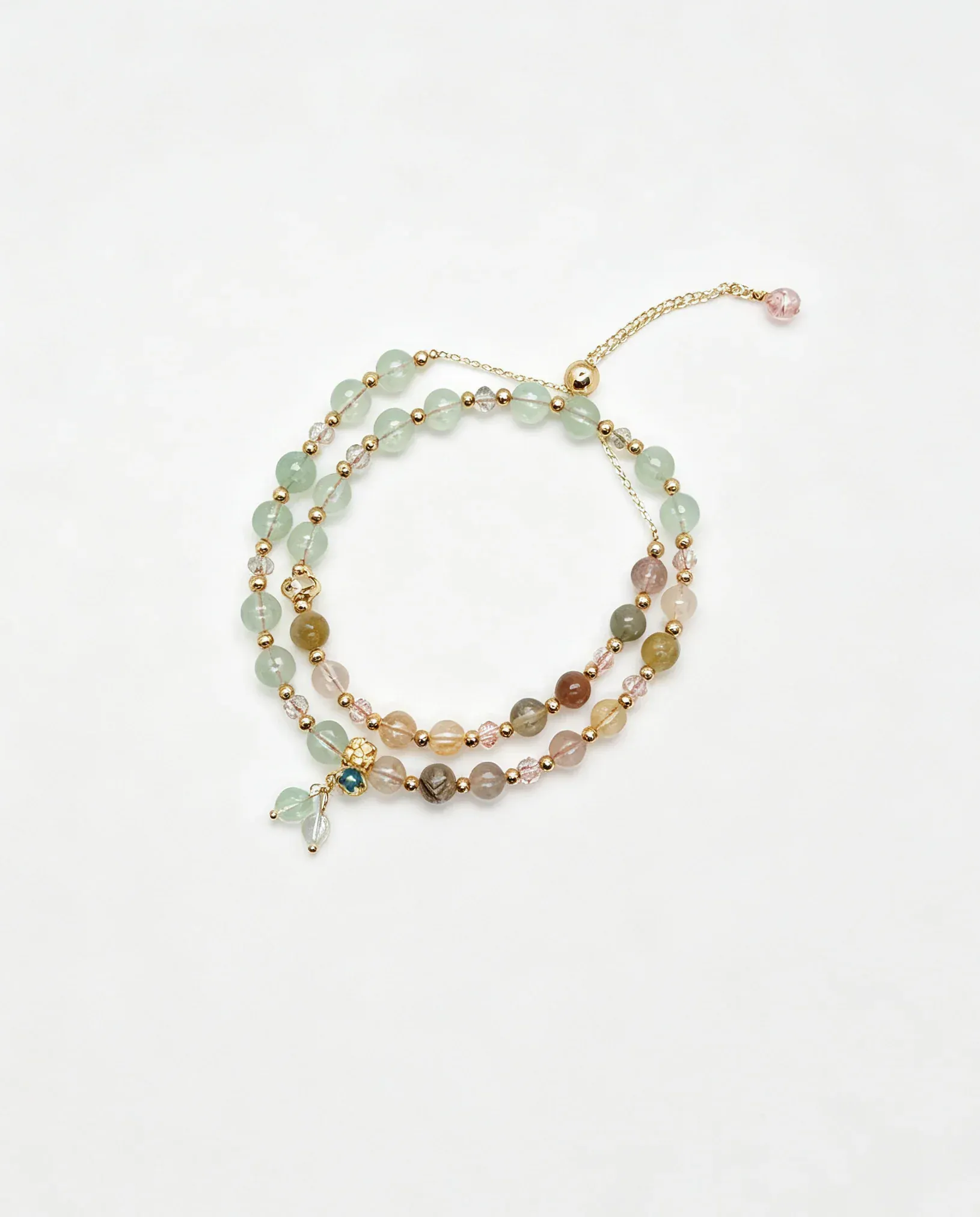 Layered natural crystal bracelet with green, pink, and gold beads, handcrafted for positive energy and healing.