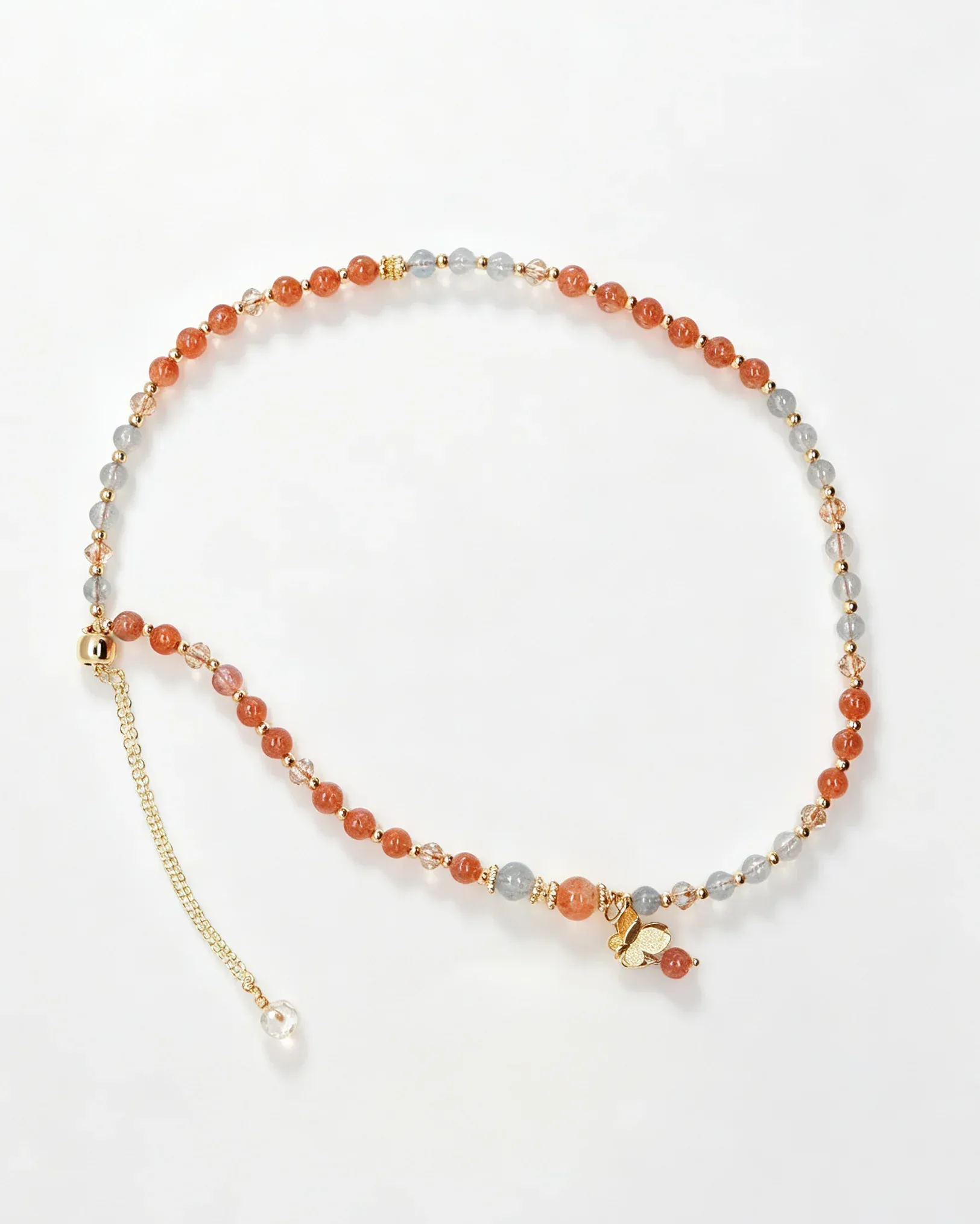 Handcrafted crystal bracelet with orange and gray beads, gold butterfly charm, and adjustable chain for positive energy.