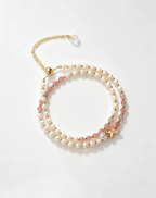 Layered pearl and pink crystal bracelet with gold butterfly charm, natural gemstone accessory for women