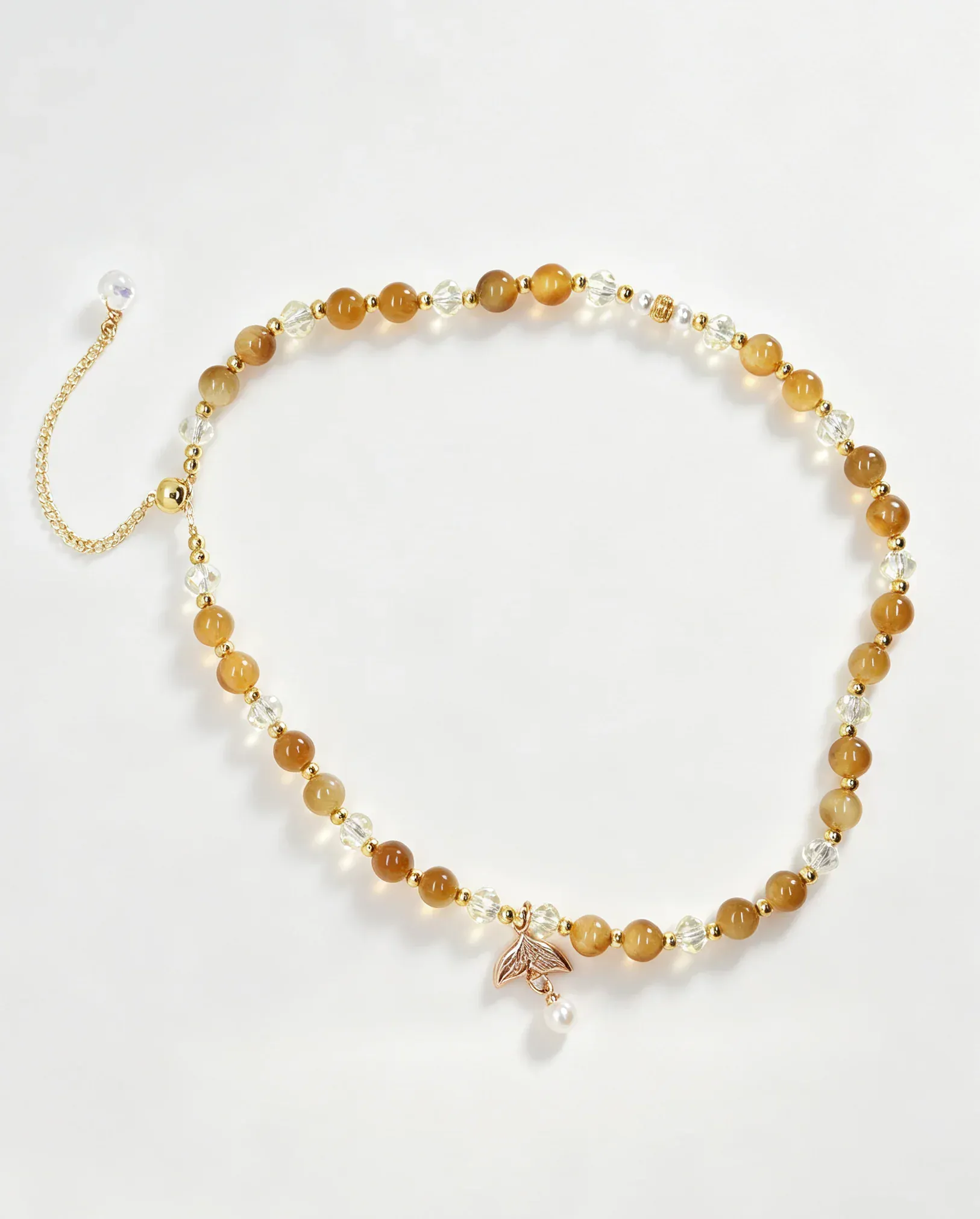 Handcrafted amber and crystal beaded bracelet with gold leaf charm, natural gemstone accessory for women