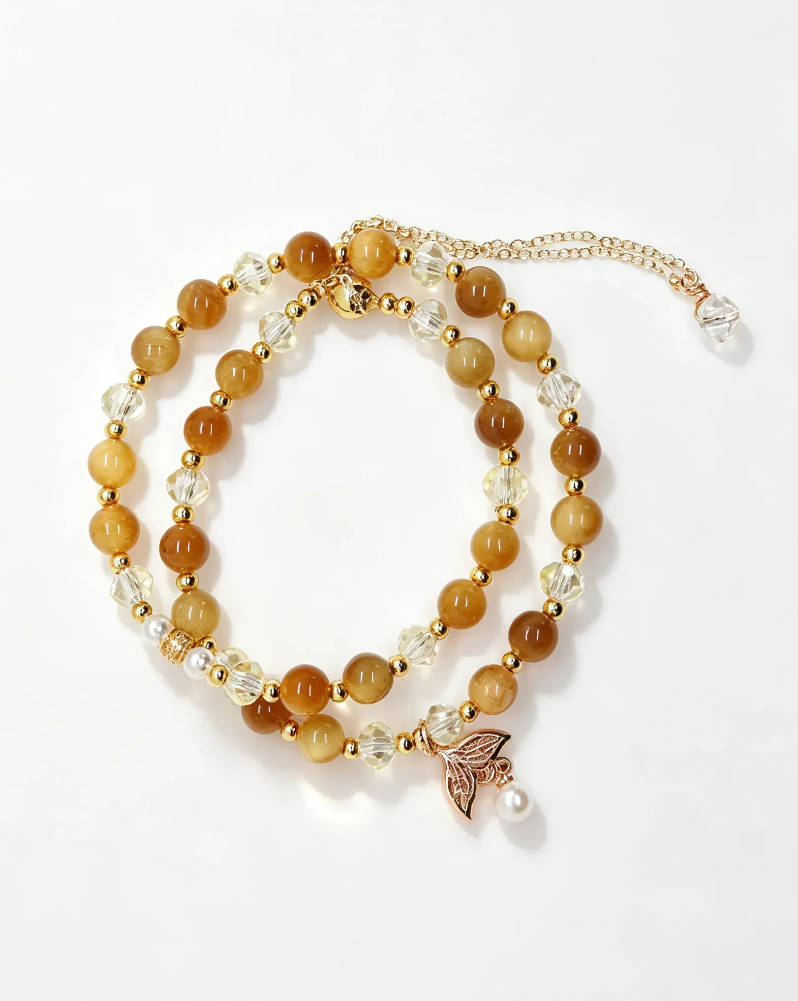 Handcrafted crystal bracelet with amber beads, clear crystals, gold accents, and a butterfly charm for positive energy.