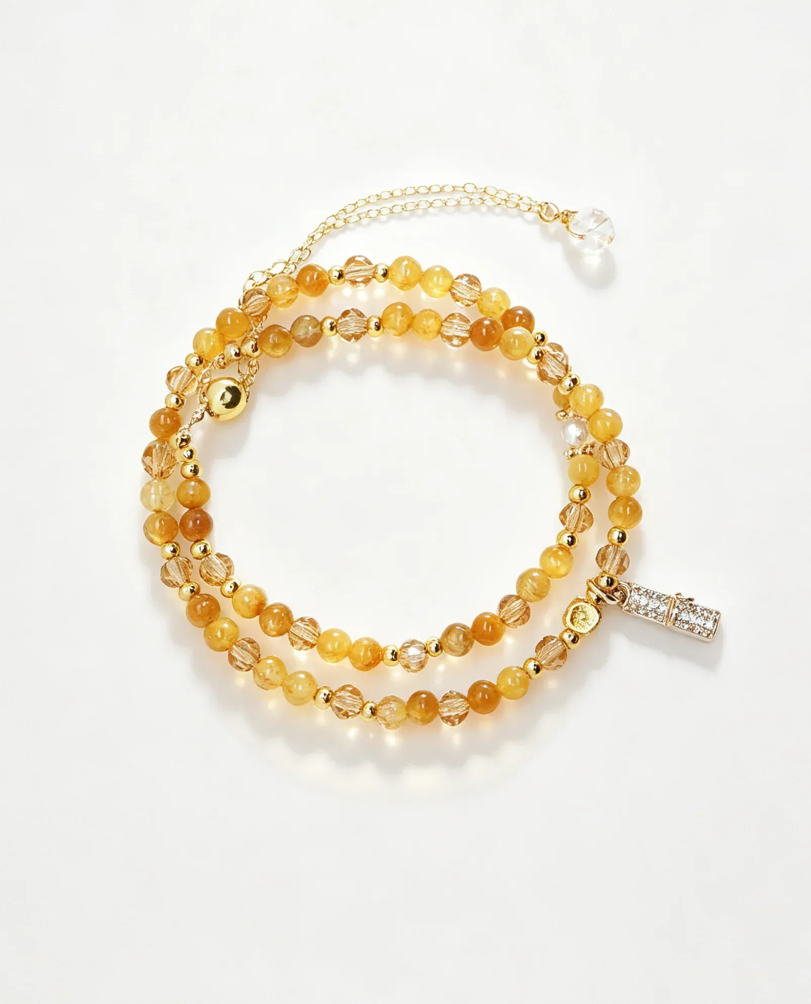 Layered amber crystal bracelet with gold beads and charm, handcrafted healing gemstone accessory for women