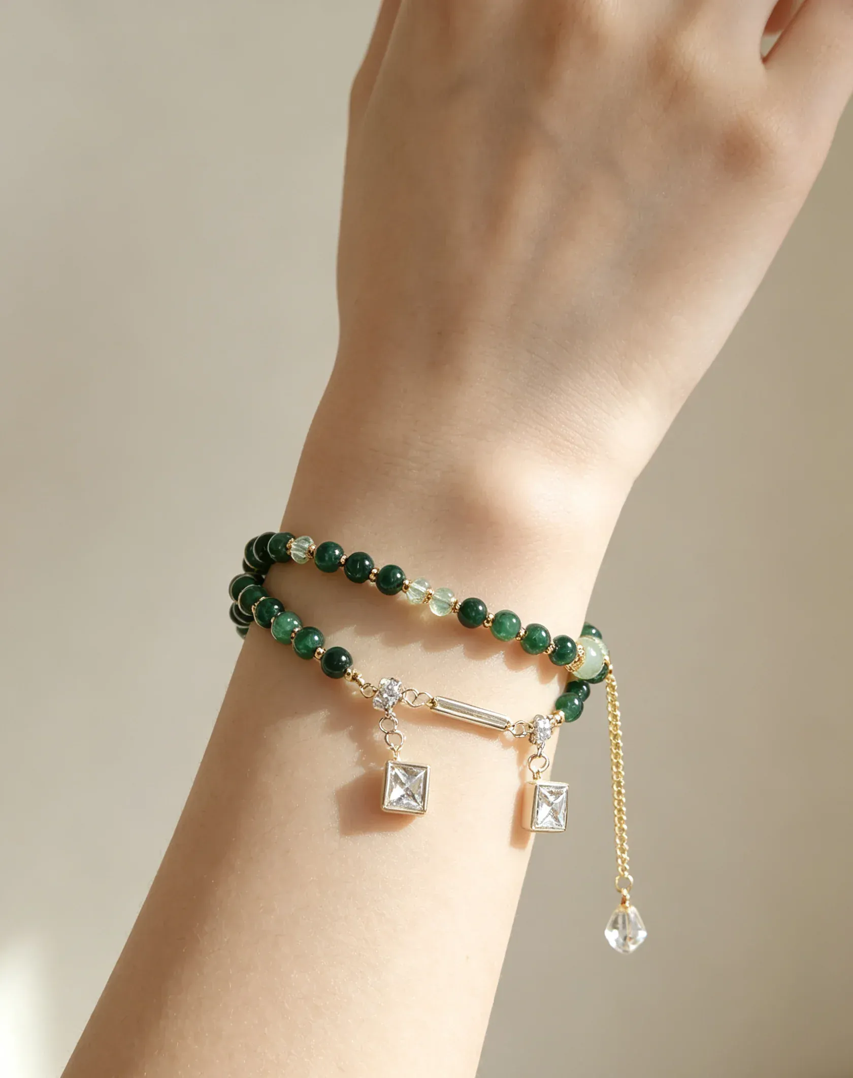 Green crystal bracelet with gold charms and dangling beads, handcrafted healing gemstone accessory for women