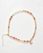Handcrafted crystal bracelet with pink gemstones, gold beads, and butterfly charm for positive energy