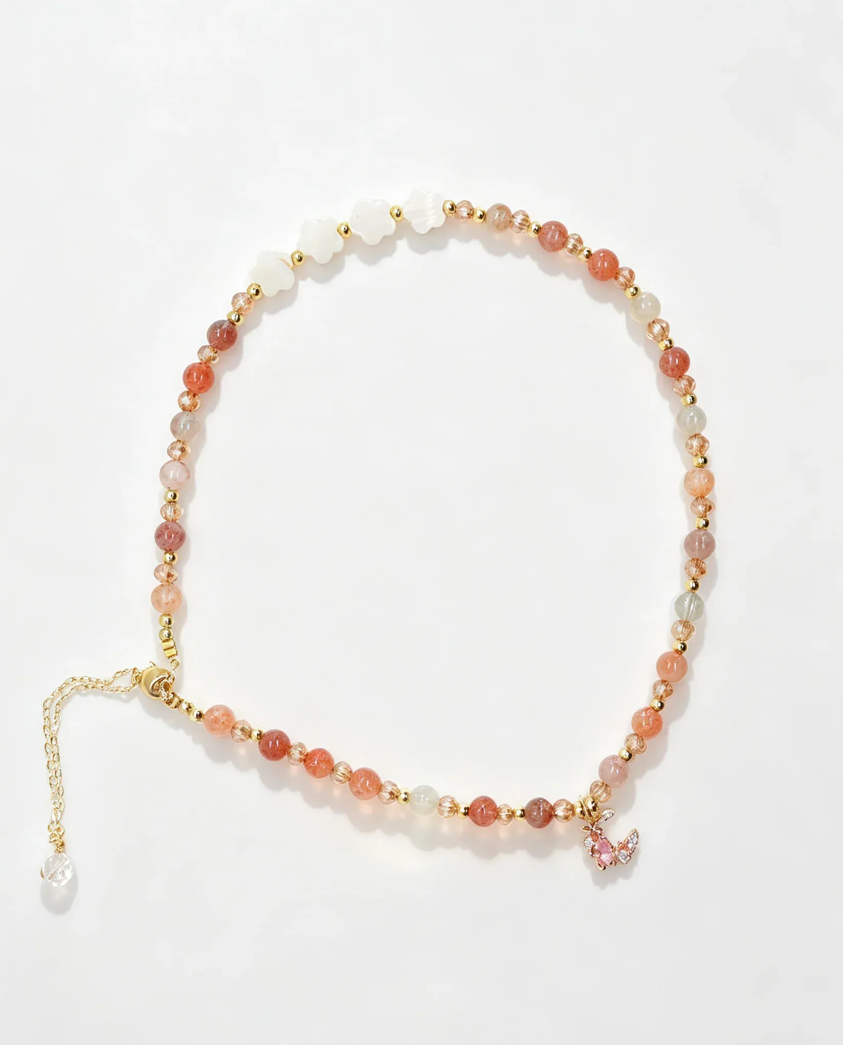 Handcrafted crystal bracelet with pink gemstones, gold beads, and butterfly charm for positive energy