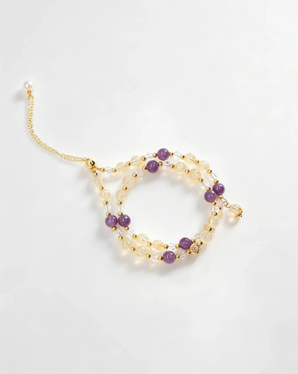 Handcrafted crystal bracelet with purple, clear, and gold beads for positive energy and healing