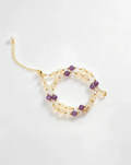 Handcrafted crystal bracelet with purple, clear, and gold beads for positive energy and healing