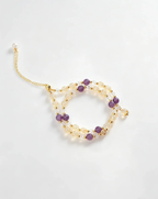 Handcrafted crystal bracelet with purple, clear, and gold beads for positive energy and healing