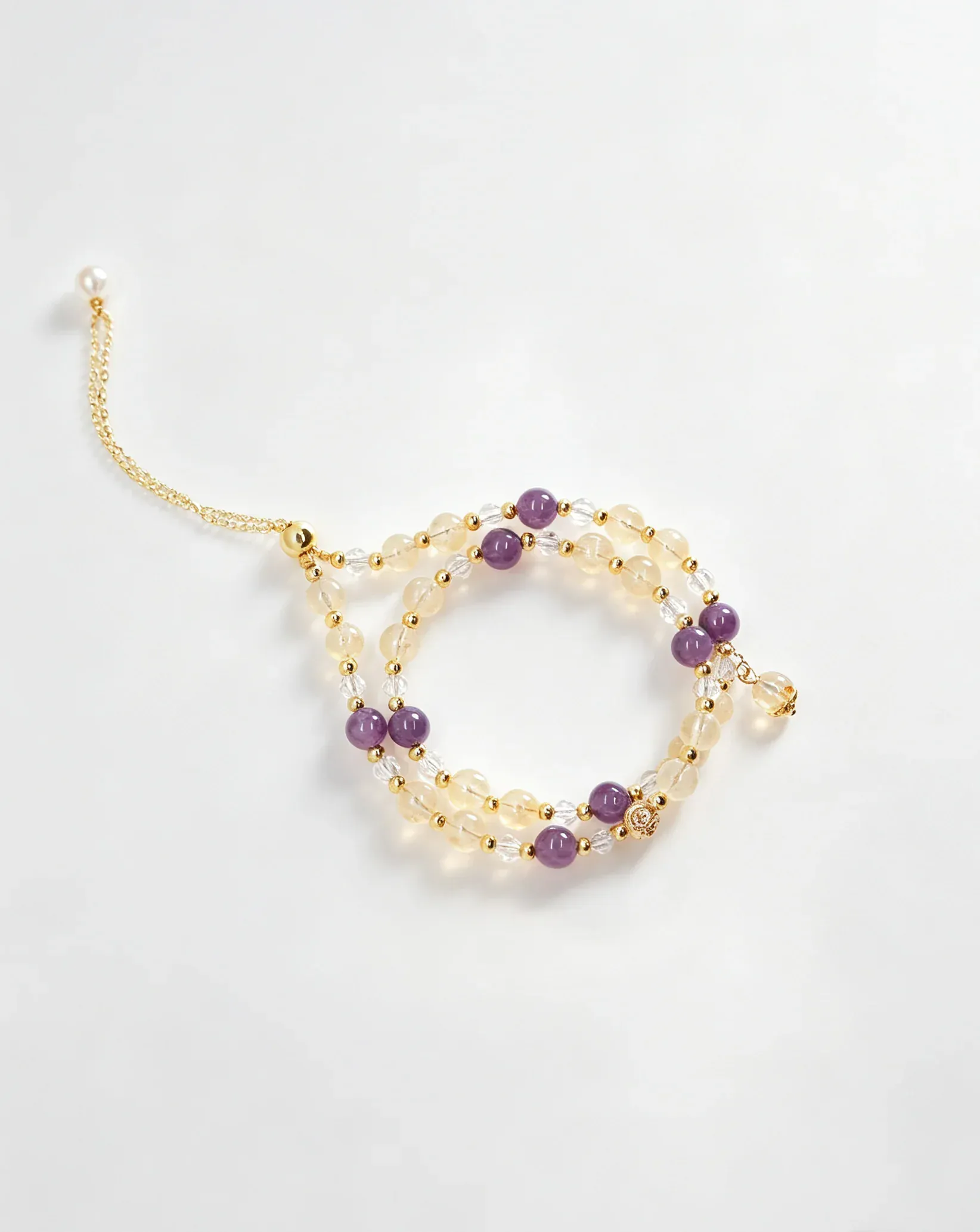 Handcrafted crystal bracelet with purple, clear, and gold beads for positive energy and healing