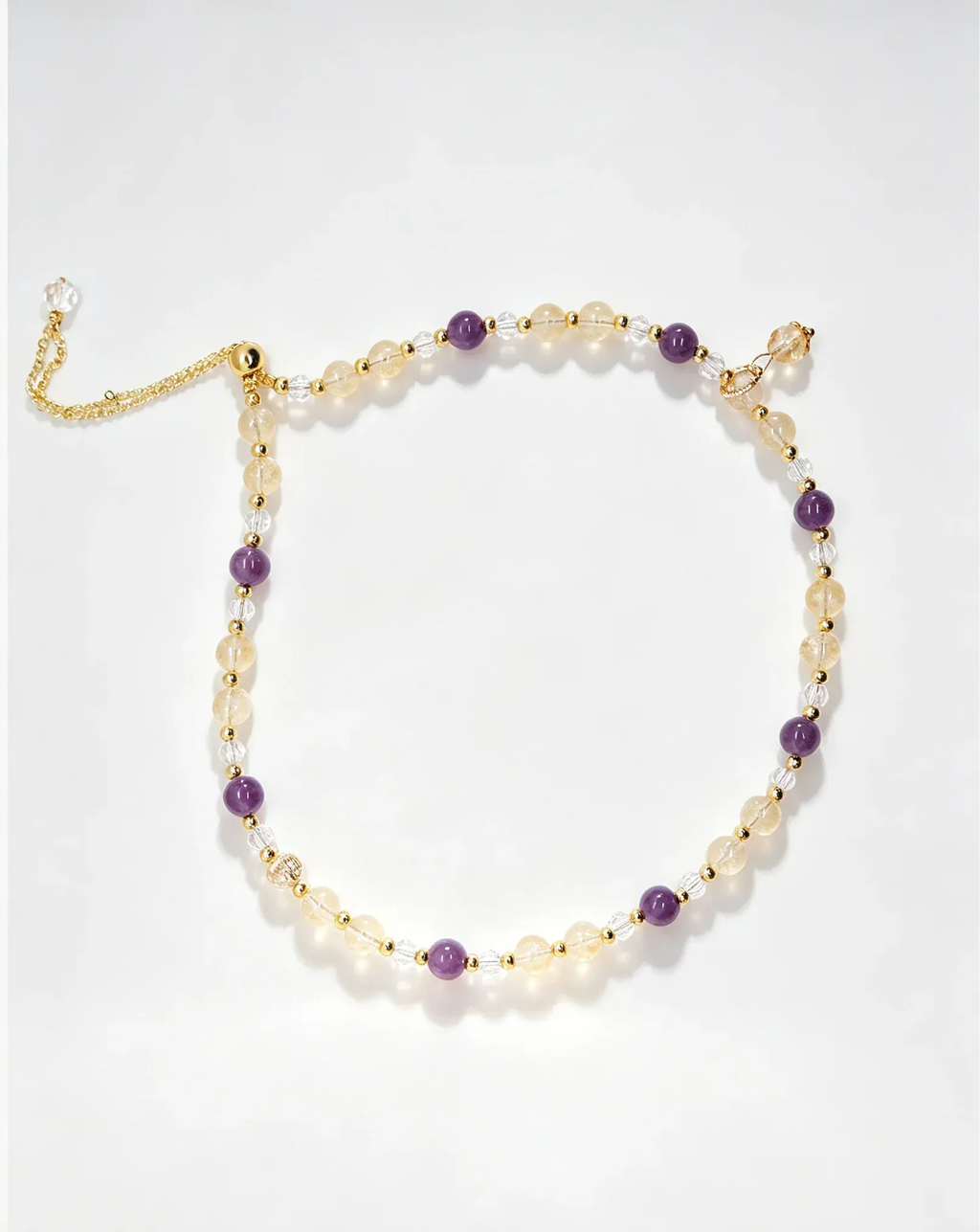 Handcrafted natural crystal bracelet with amethyst, citrine, and clear beads for positive energy and healing.