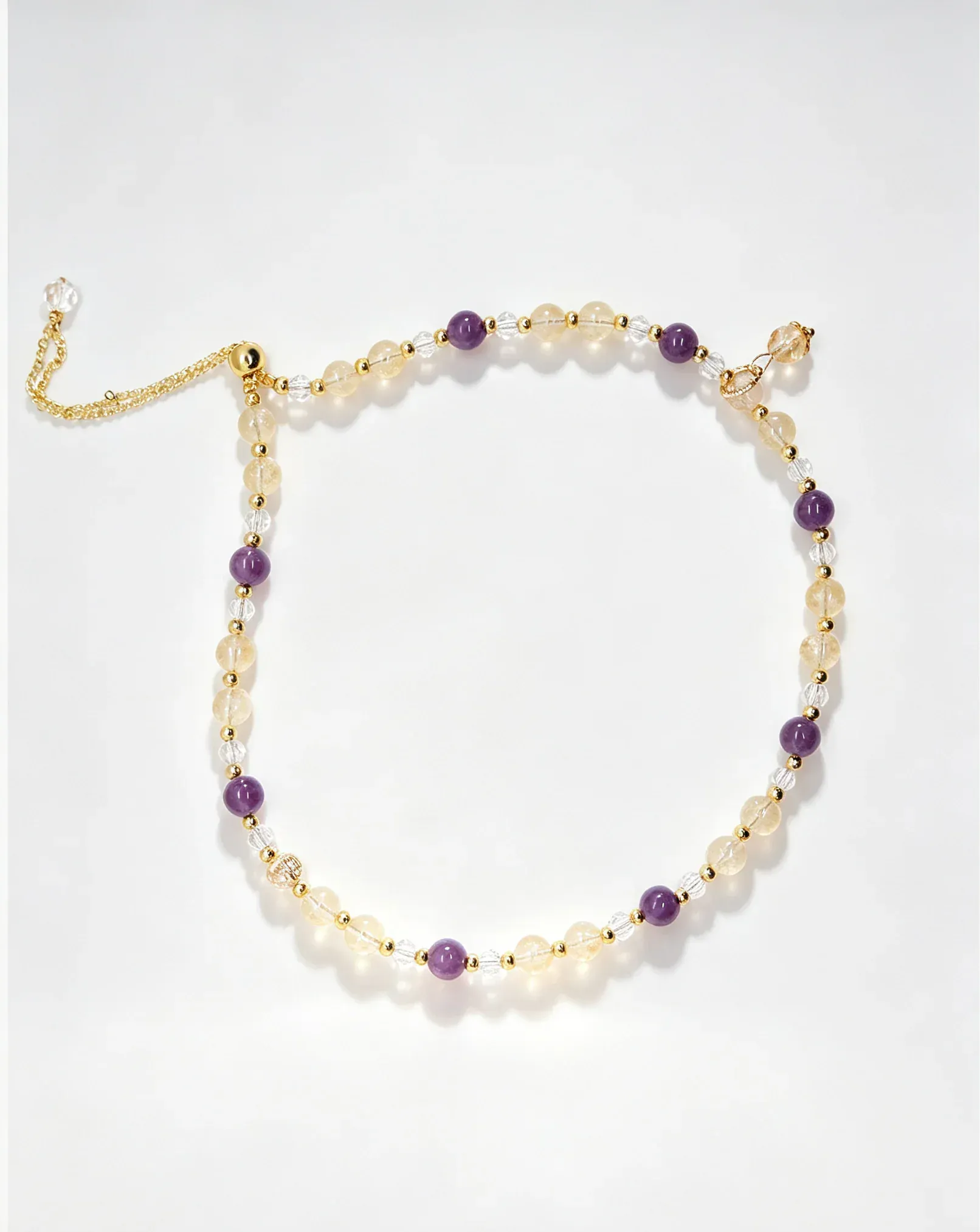 Handcrafted natural crystal bracelet with amethyst, citrine, and clear beads for positive energy and healing.