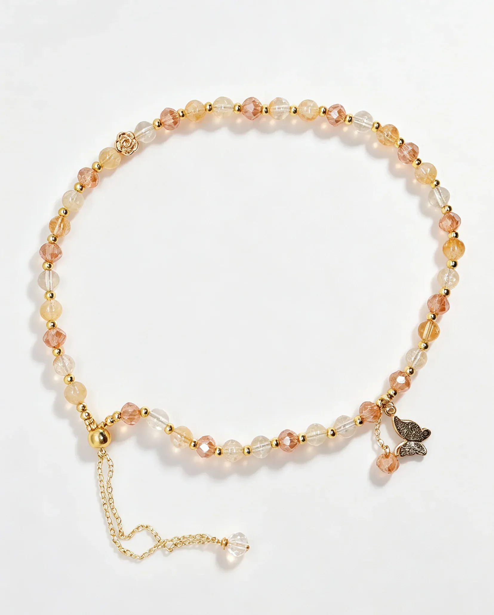 Handcrafted crystal bracelet with peach and clear beads, gold accents, and butterfly charm for positive energy