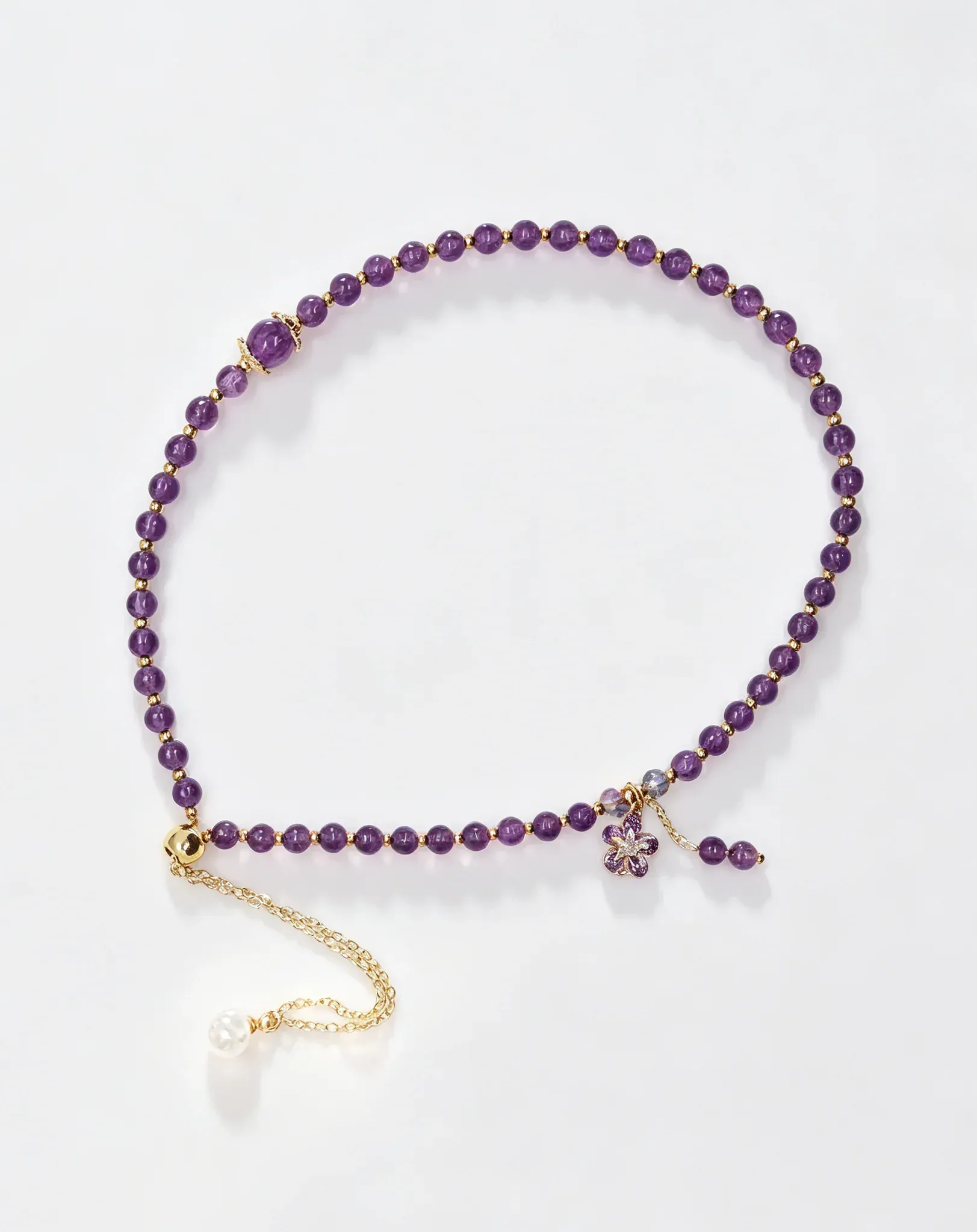 Purple amethyst crystal bracelet with gold chain and flower charm, healing gemstone accessory for women