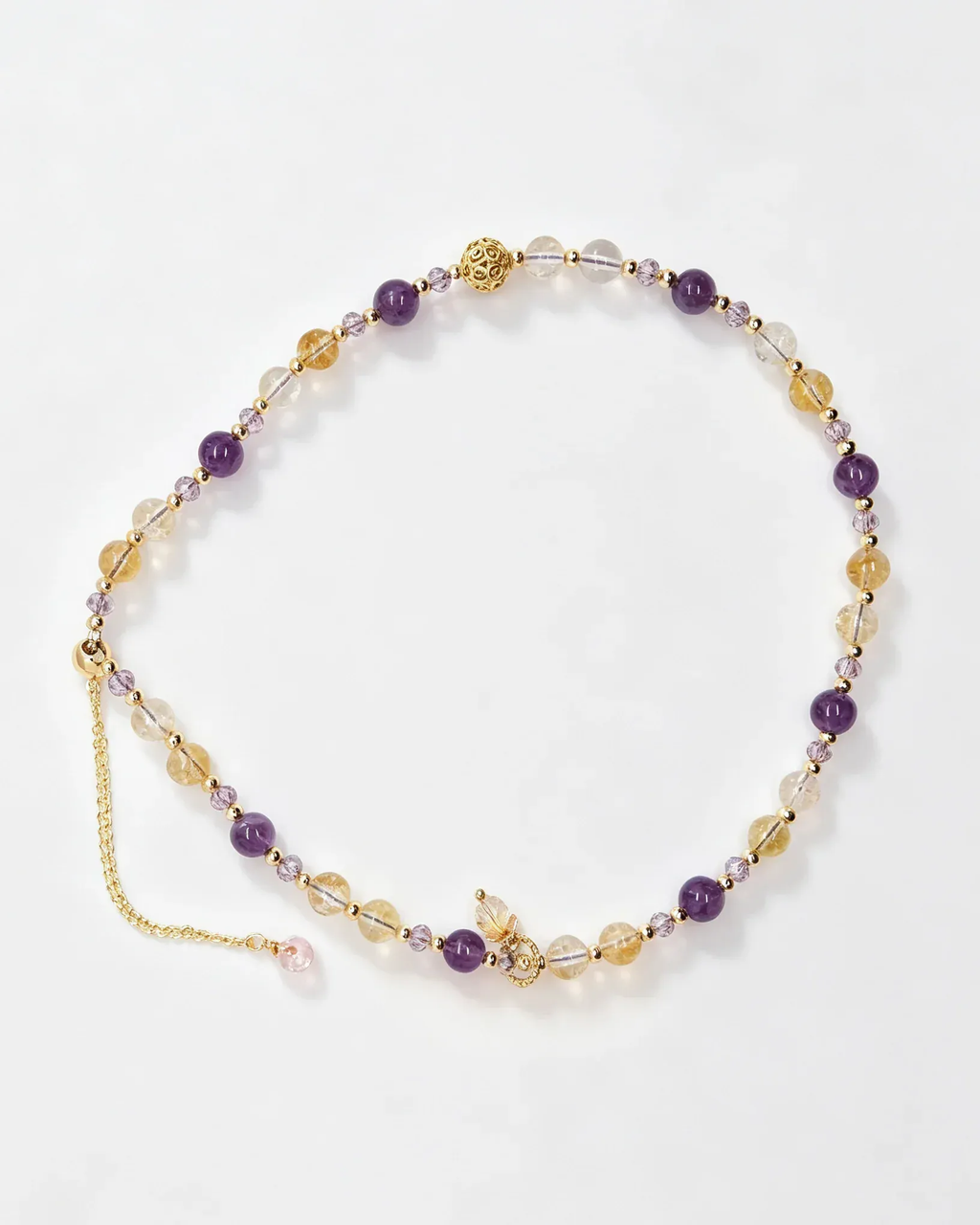 Handcrafted natural crystal bracelet with amethyst, citrine, and gold accents for positive energy and healing.