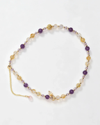 Handcrafted natural crystal bracelet with amethyst, citrine, and gold accents for positive energy and healing.