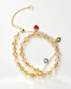 Layered natural crystal bracelet with gold chain, heart charms, and healing gemstones for positive energy