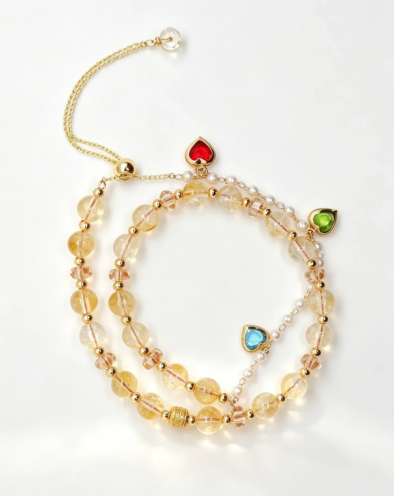 Layered natural crystal bracelet with gold chain, heart charms, and healing gemstones for positive energy