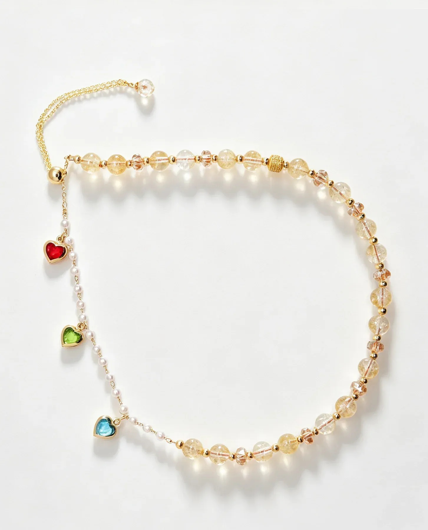 Handcrafted crystal bracelet with gold chain, heart charms, and natural gemstones for positive energy